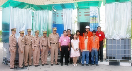 Company officials and Thai Navy officers prepare to ship out the floating toilets.